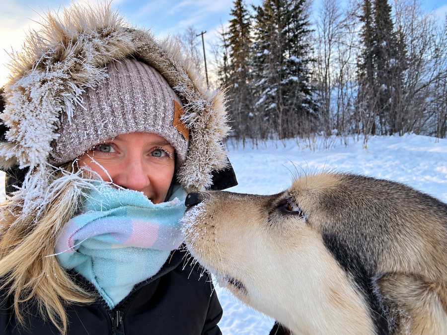 Melissa outside in winter gear with her dog